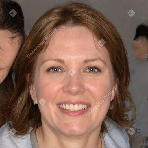 Joyful white adult female with medium  brown hair and blue eyes