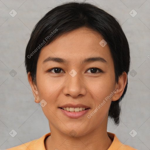 Joyful asian young-adult female with short  black hair and brown eyes