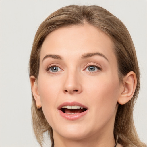 Joyful white young-adult female with medium  brown hair and grey eyes