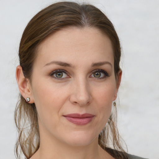 Joyful white young-adult female with long  brown hair and grey eyes