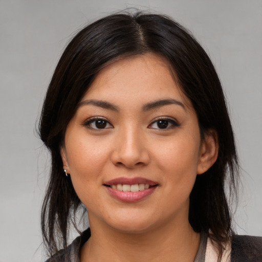 Joyful asian young-adult female with medium  brown hair and brown eyes