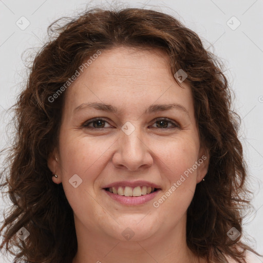 Joyful white adult female with long  brown hair and brown eyes