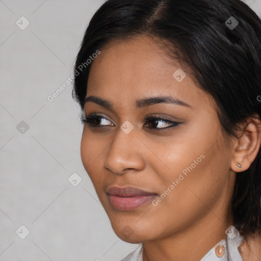 Joyful latino young-adult female with short  black hair and brown eyes