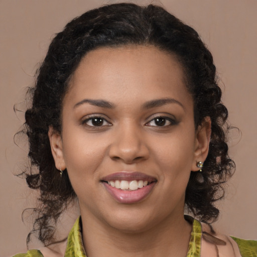 Joyful black young-adult female with medium  brown hair and brown eyes