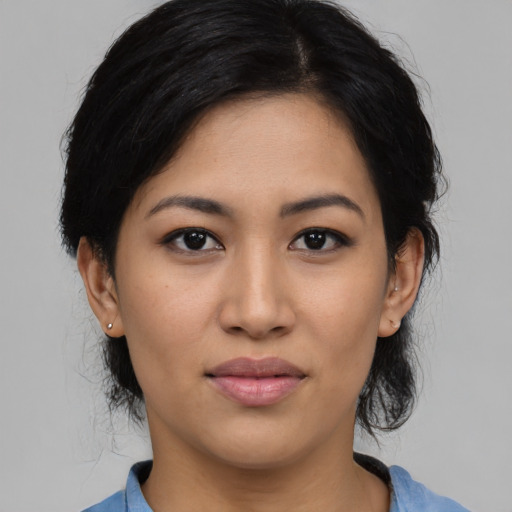 Joyful latino young-adult female with medium  black hair and brown eyes