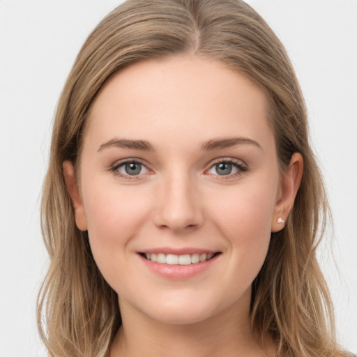 Joyful white young-adult female with long  brown hair and grey eyes