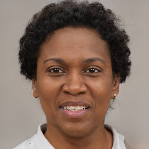 Joyful black adult female with short  brown hair and brown eyes