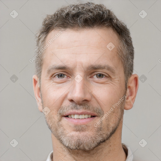 Joyful white adult male with short  brown hair and brown eyes