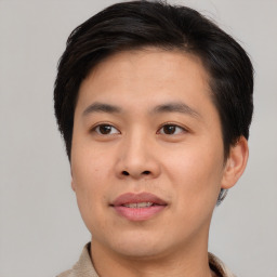 Joyful asian young-adult male with short  brown hair and brown eyes