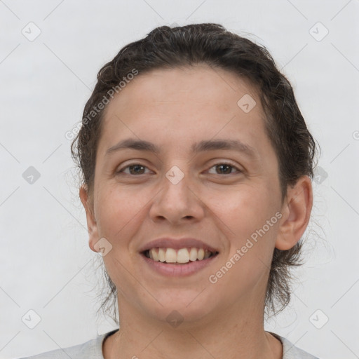 Joyful white young-adult female with short  brown hair and brown eyes