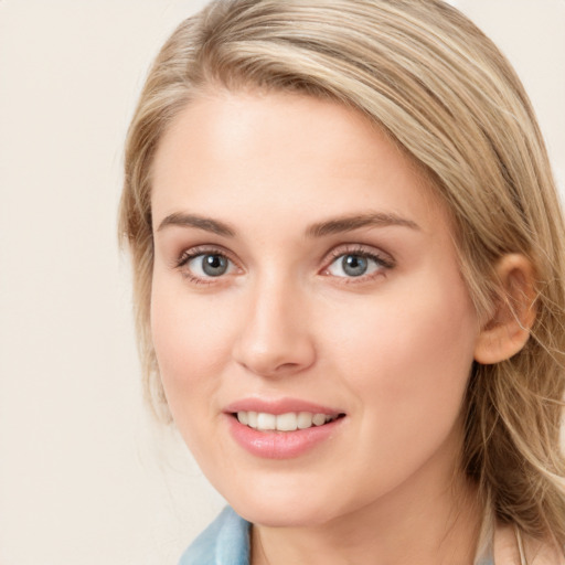 Joyful white young-adult female with long  brown hair and blue eyes