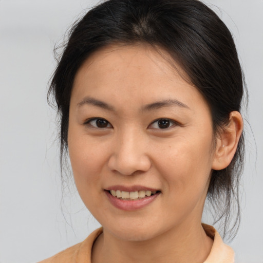 Joyful asian young-adult female with medium  brown hair and brown eyes