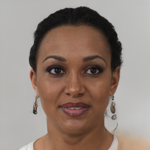 Joyful black adult female with short  black hair and brown eyes