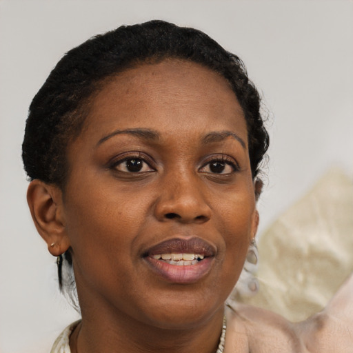 Joyful black adult female with short  brown hair and brown eyes