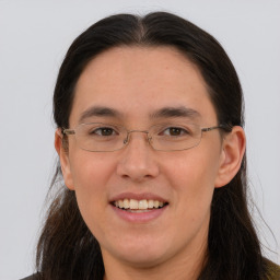 Joyful white adult female with long  brown hair and brown eyes