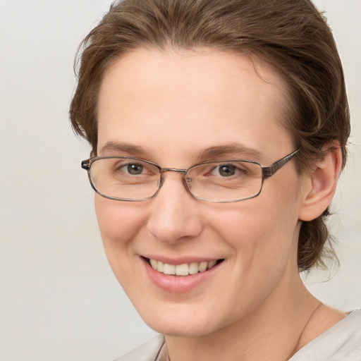 Joyful white adult female with short  brown hair and grey eyes