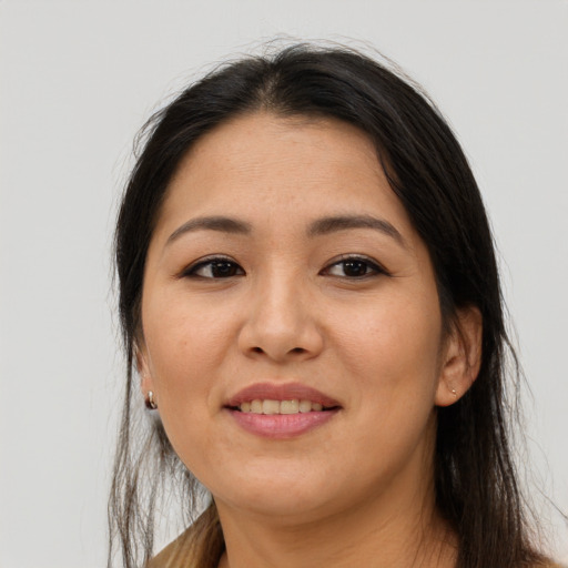Joyful asian adult female with long  brown hair and brown eyes