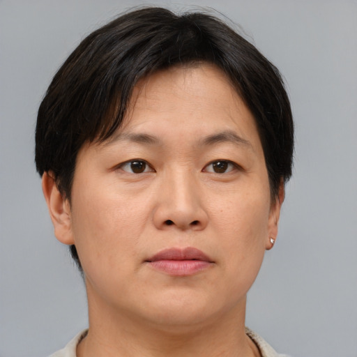 Neutral asian adult female with short  brown hair and brown eyes