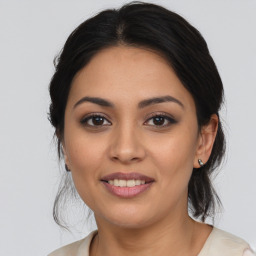 Joyful latino young-adult female with medium  brown hair and brown eyes