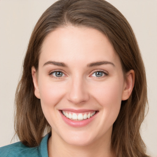 Joyful white young-adult female with long  brown hair and grey eyes