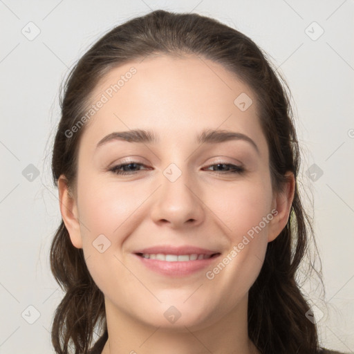 Joyful white young-adult female with long  brown hair and grey eyes