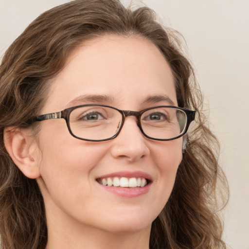 Joyful white young-adult female with long  brown hair and green eyes