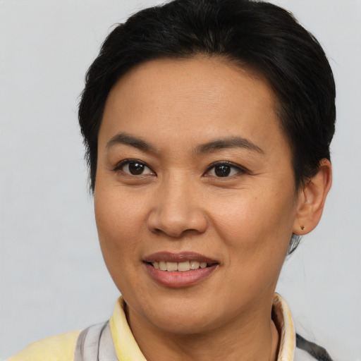 Joyful latino adult female with short  brown hair and brown eyes