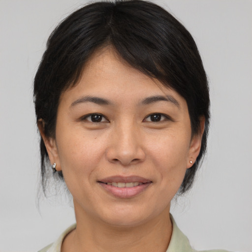 Joyful asian adult female with medium  brown hair and brown eyes