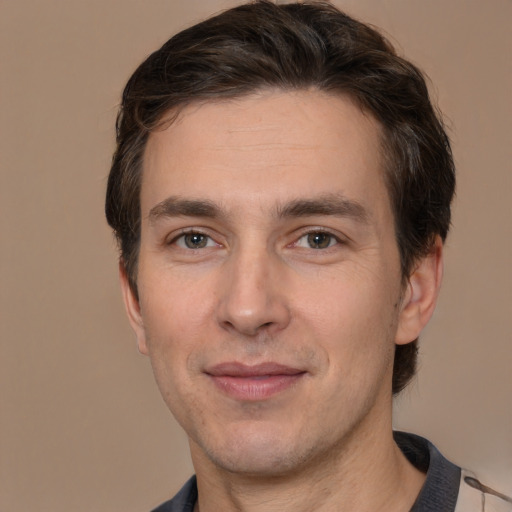 Joyful white adult male with short  brown hair and brown eyes