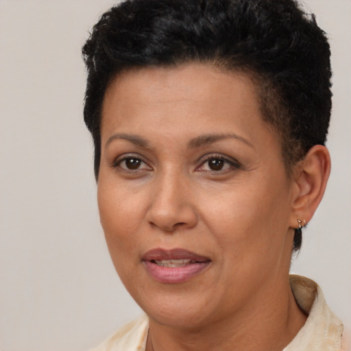 Joyful latino adult female with short  brown hair and brown eyes