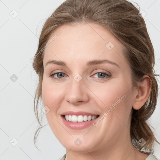 Joyful white young-adult female with medium  brown hair and blue eyes