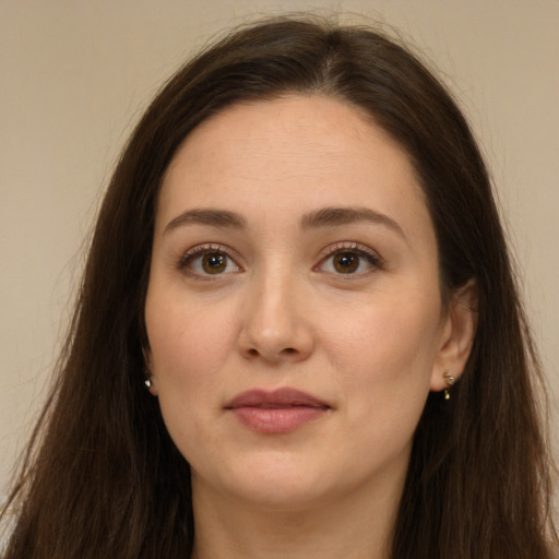 Joyful white young-adult female with long  brown hair and brown eyes