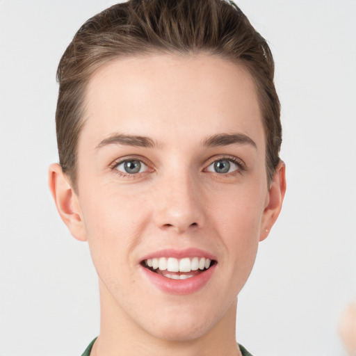 Joyful white young-adult female with short  brown hair and grey eyes