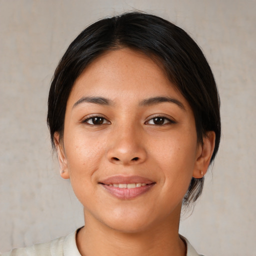 Joyful latino young-adult female with medium  brown hair and brown eyes