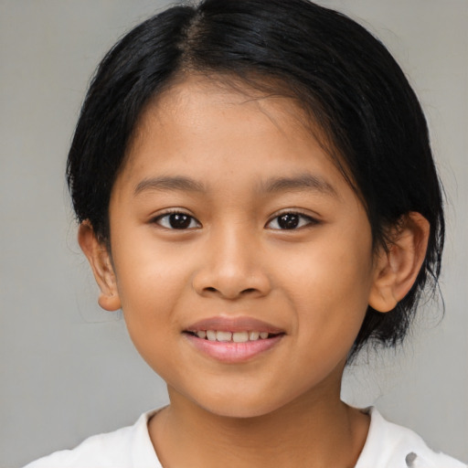 Joyful latino child female with medium  brown hair and brown eyes