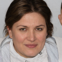 Joyful white young-adult female with medium  brown hair and blue eyes