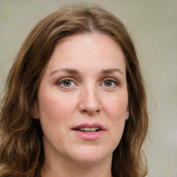 Joyful white young-adult female with medium  brown hair and green eyes