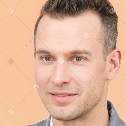 Joyful white adult male with short  brown hair and brown eyes