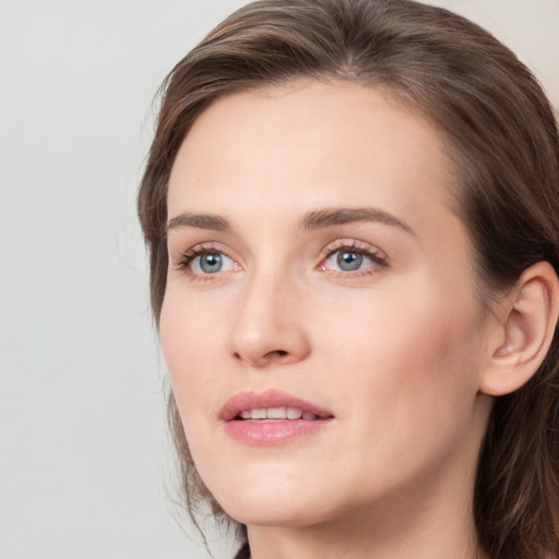 Joyful white young-adult female with medium  brown hair and green eyes