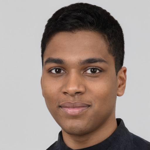 Joyful black young-adult male with short  black hair and brown eyes