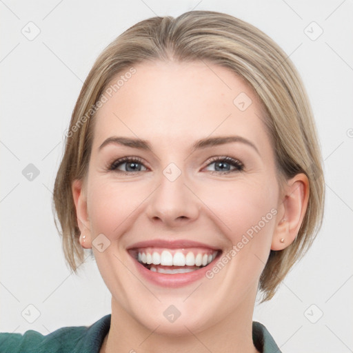 Joyful white young-adult female with medium  brown hair and blue eyes