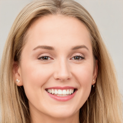 Joyful white young-adult female with long  brown hair and brown eyes