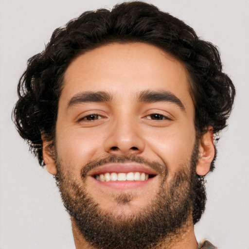 Joyful white young-adult male with short  black hair and brown eyes