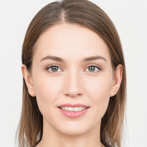 Joyful white young-adult female with long  brown hair and grey eyes