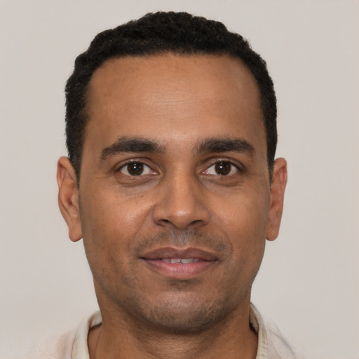 Joyful white young-adult male with short  black hair and brown eyes