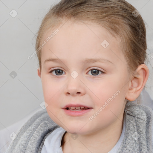 Joyful white child female with short  brown hair and blue eyes