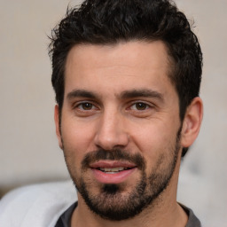 Joyful white young-adult male with short  black hair and brown eyes