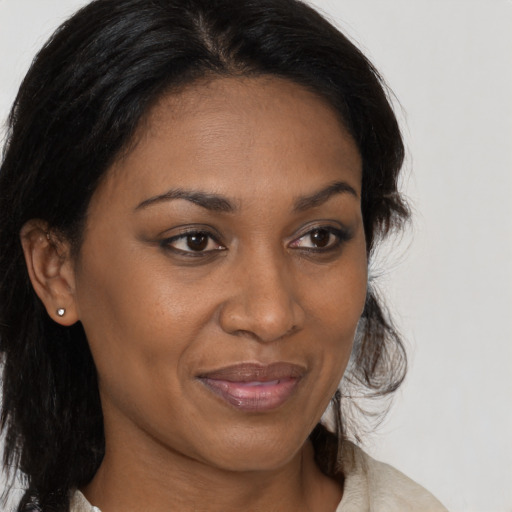 Joyful black young-adult female with medium  brown hair and brown eyes