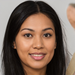 Joyful asian young-adult female with long  brown hair and brown eyes