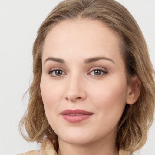 Joyful white young-adult female with long  brown hair and green eyes